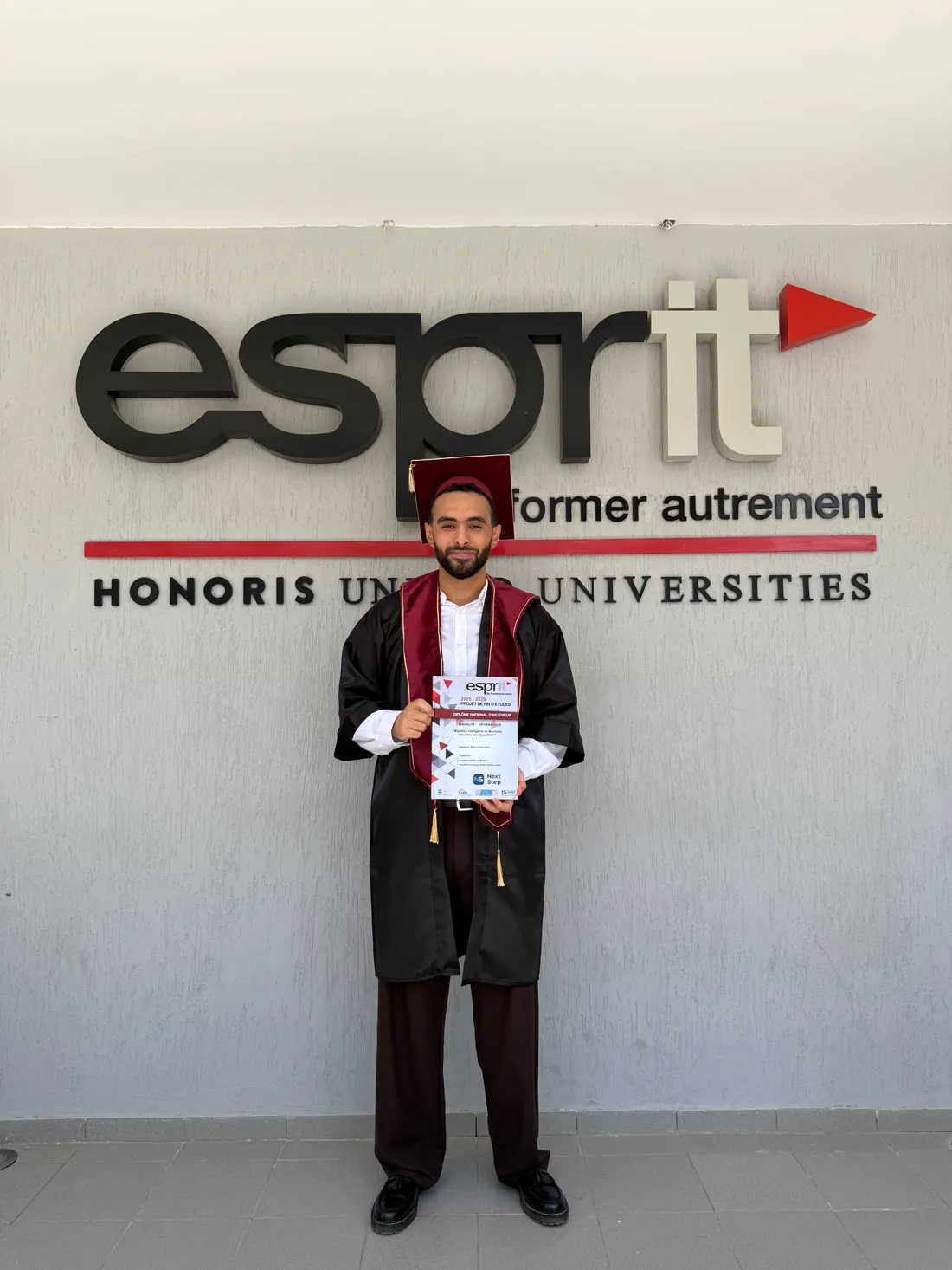 Ahmed Habib Mezni on graduation day at ESPRIT, holding his end-of-studies project